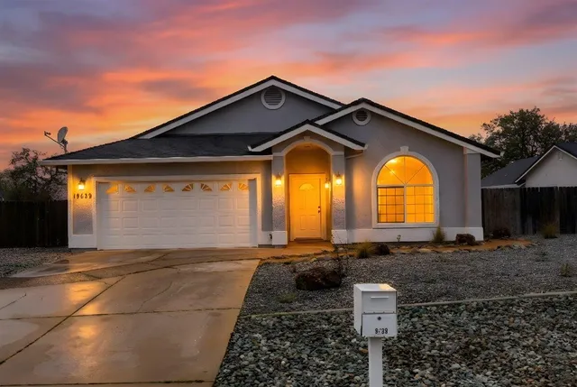 a front view of a house with a yard