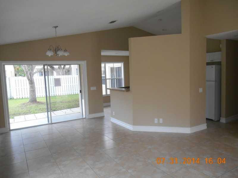 926 Falling Water Road Weston, FL 33326 - Photo 4 of 24 a view of an empty room with glass door