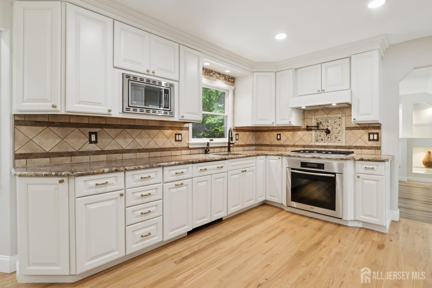 3 Cedar Lane Milltown, NJ 08850 - Photo 13 of 67 a kitchen with stainless steel appliances granite countertop a stove a sink and white cabinets