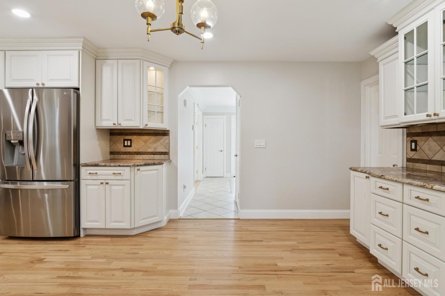 3 Cedar Lane Milltown, NJ 08850 - Photo 16 of 67 a kitchen with granite countertop a refrigerator stove and wooden cabinets