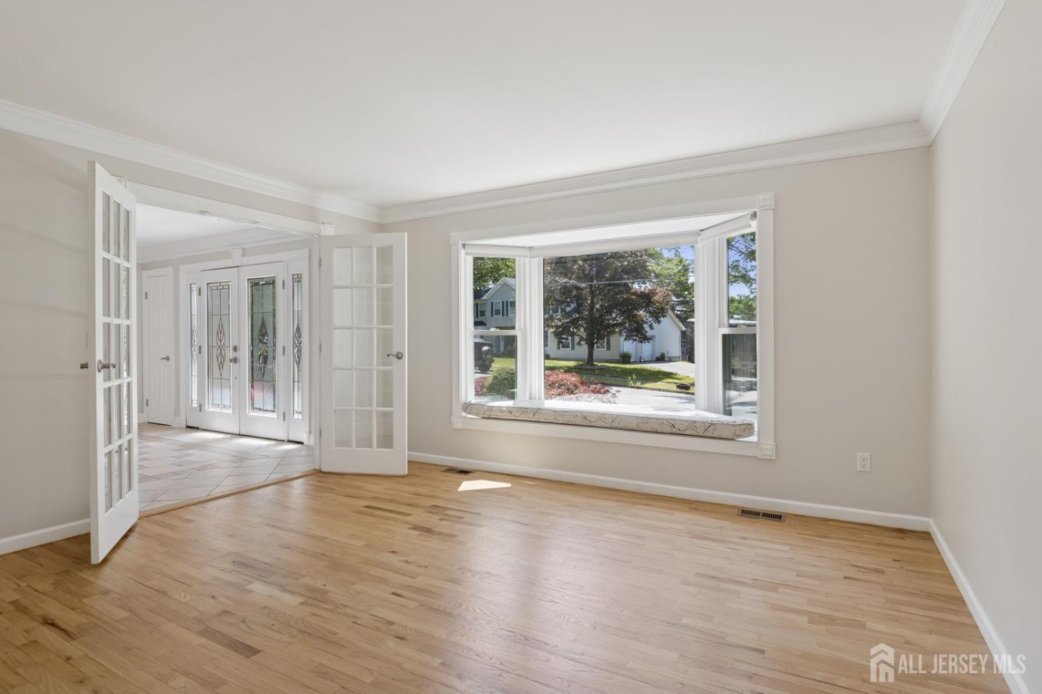 3 Cedar Lane Milltown, NJ 08850 - Photo 22 of 67 a view of empty room with wooden floor and fan