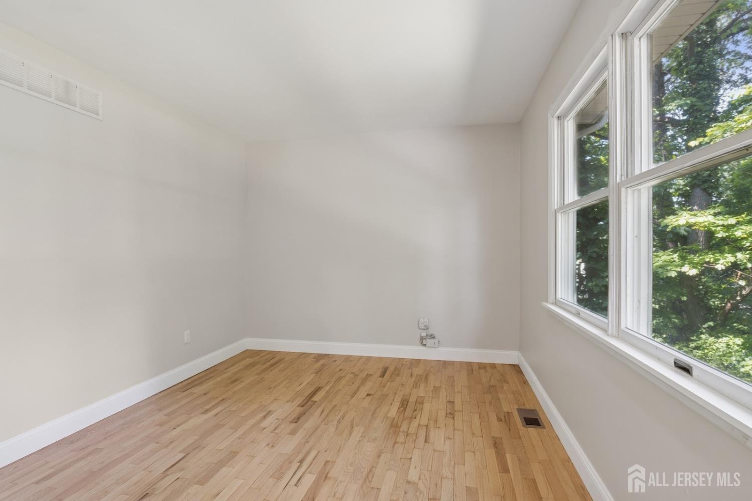 3 Cedar Lane Milltown, NJ 08850 - Photo 28 of 67 a view of a room that has wooden floor and white walls