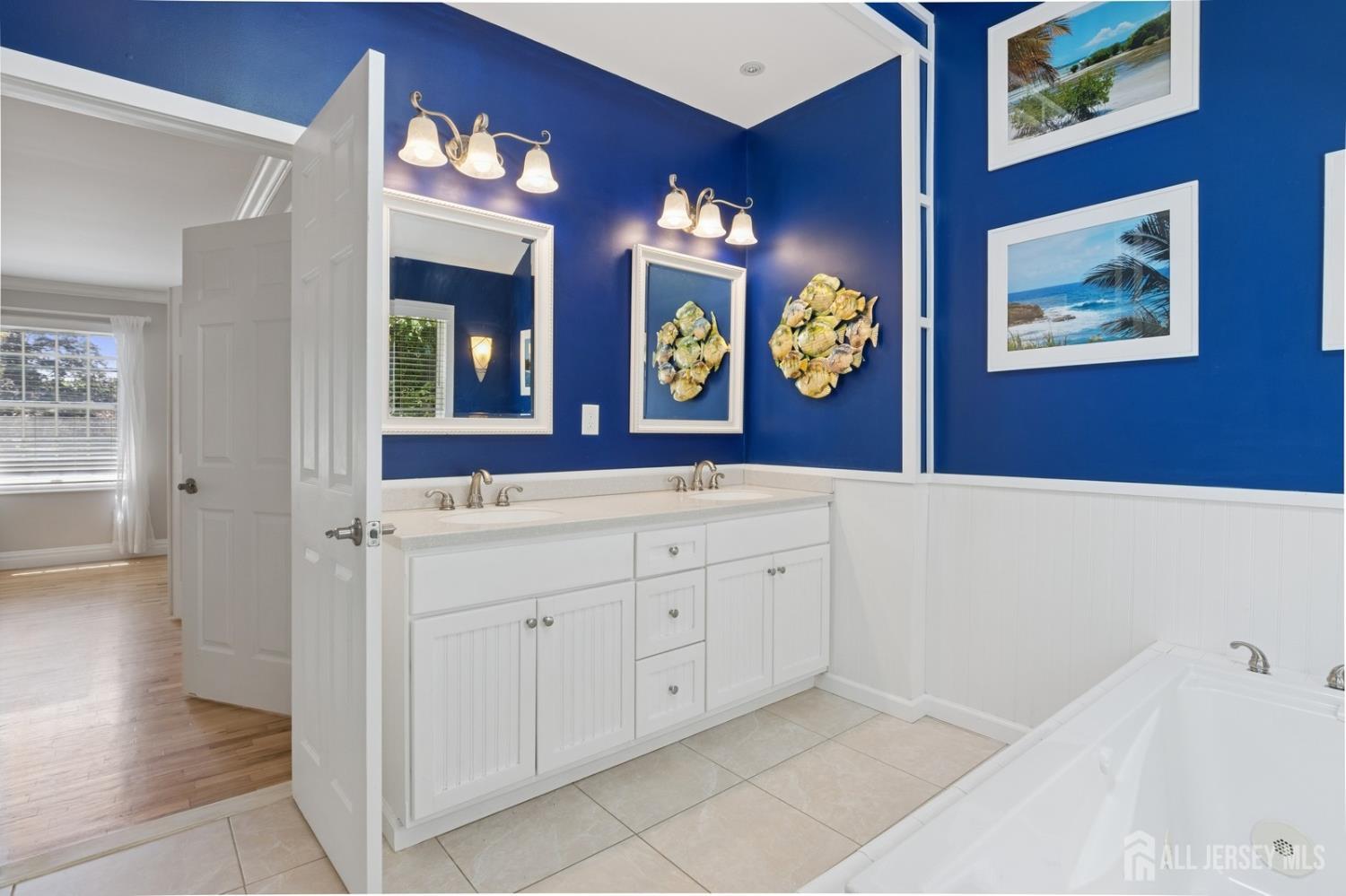 3 Cedar Lane Milltown, NJ 08850 - Photo 35 of 67 a bathroom with a sink a vanity and a mirror