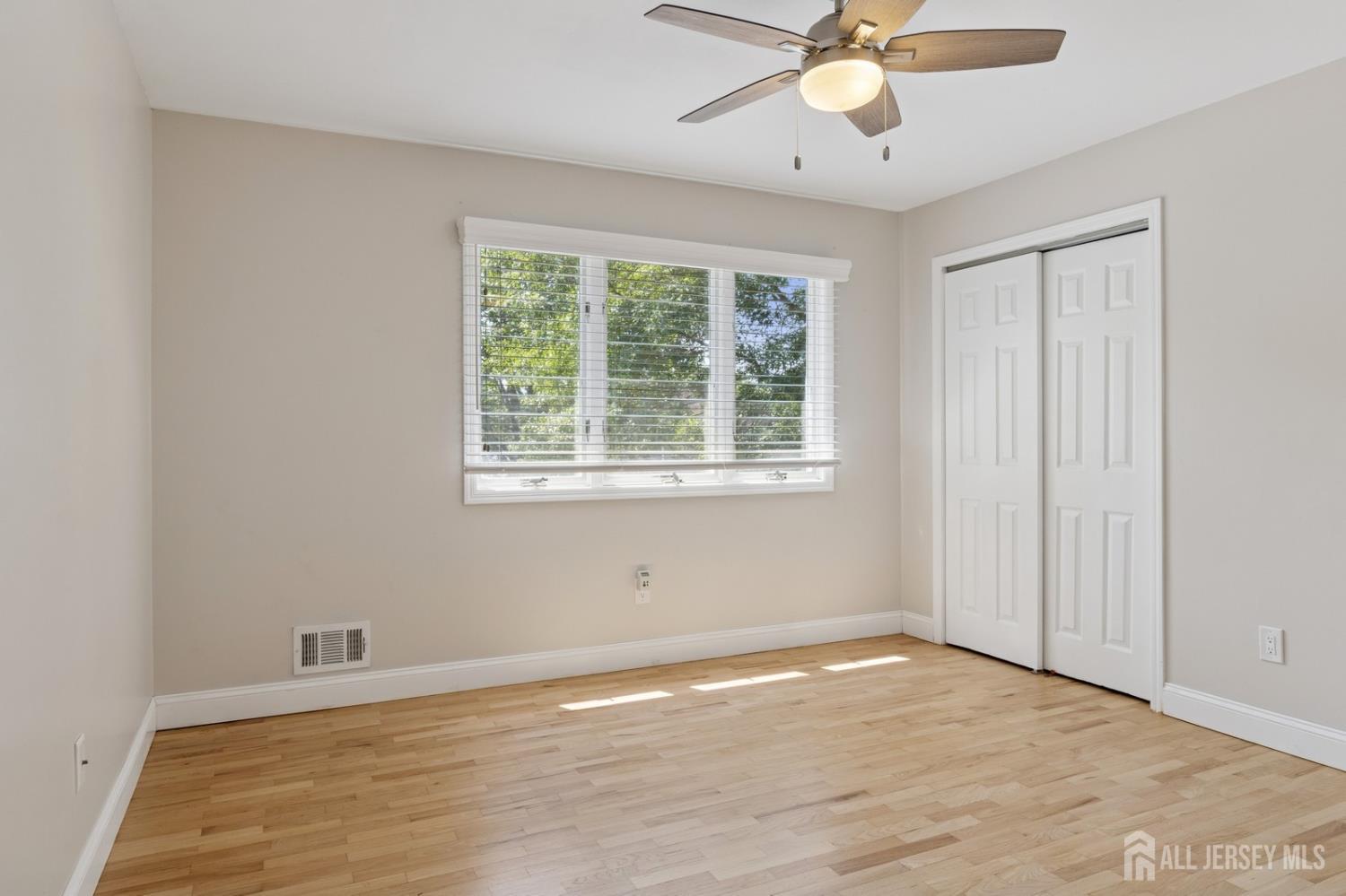 3 Cedar Lane Milltown, NJ 08850 - Photo 38 of 67 a view of an empty room with wooden floor and a window