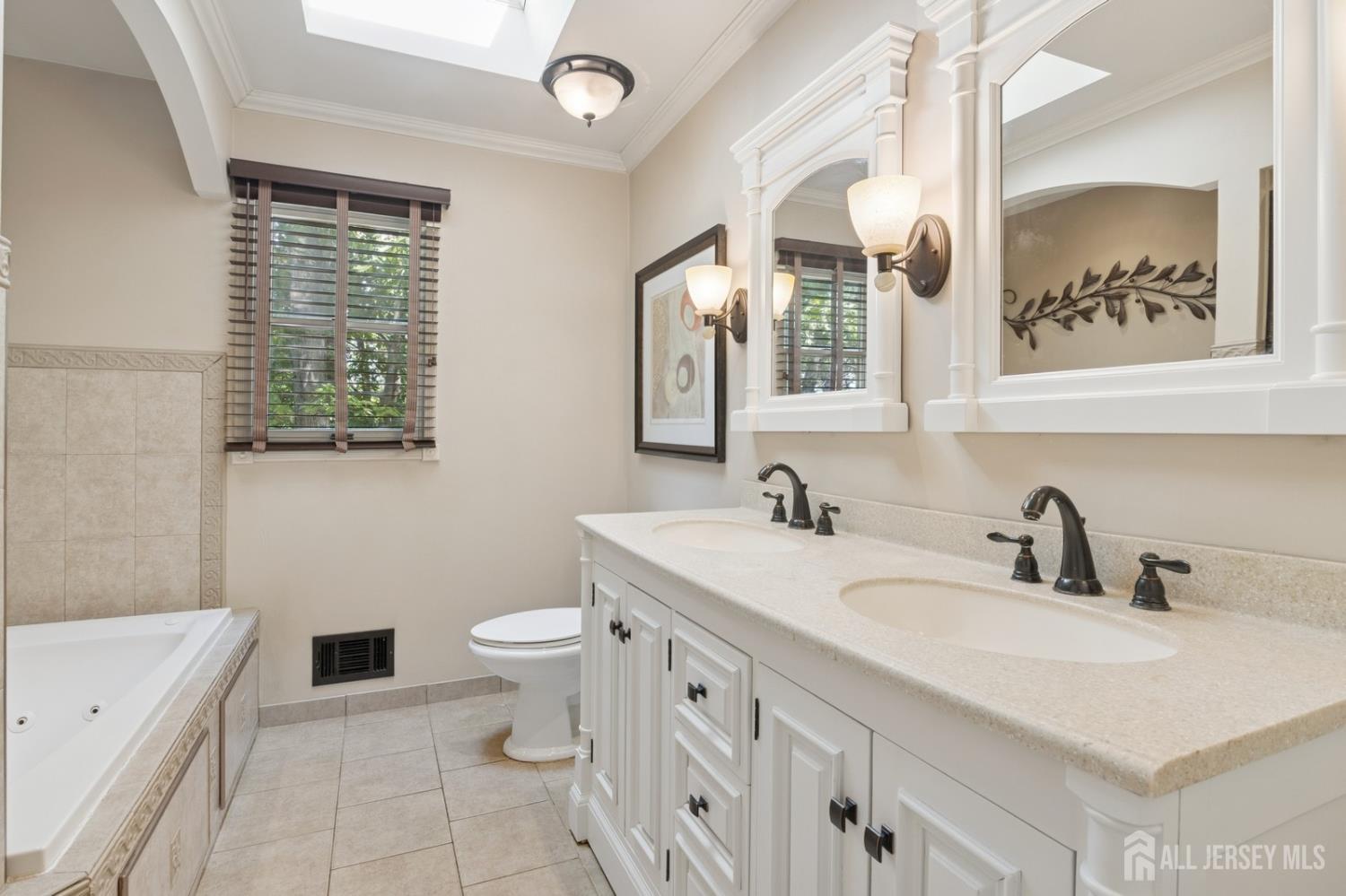 3 Cedar Lane Milltown, NJ 08850 - Photo 42 of 67 a bathroom with a double vanity sink toilet and a mirror