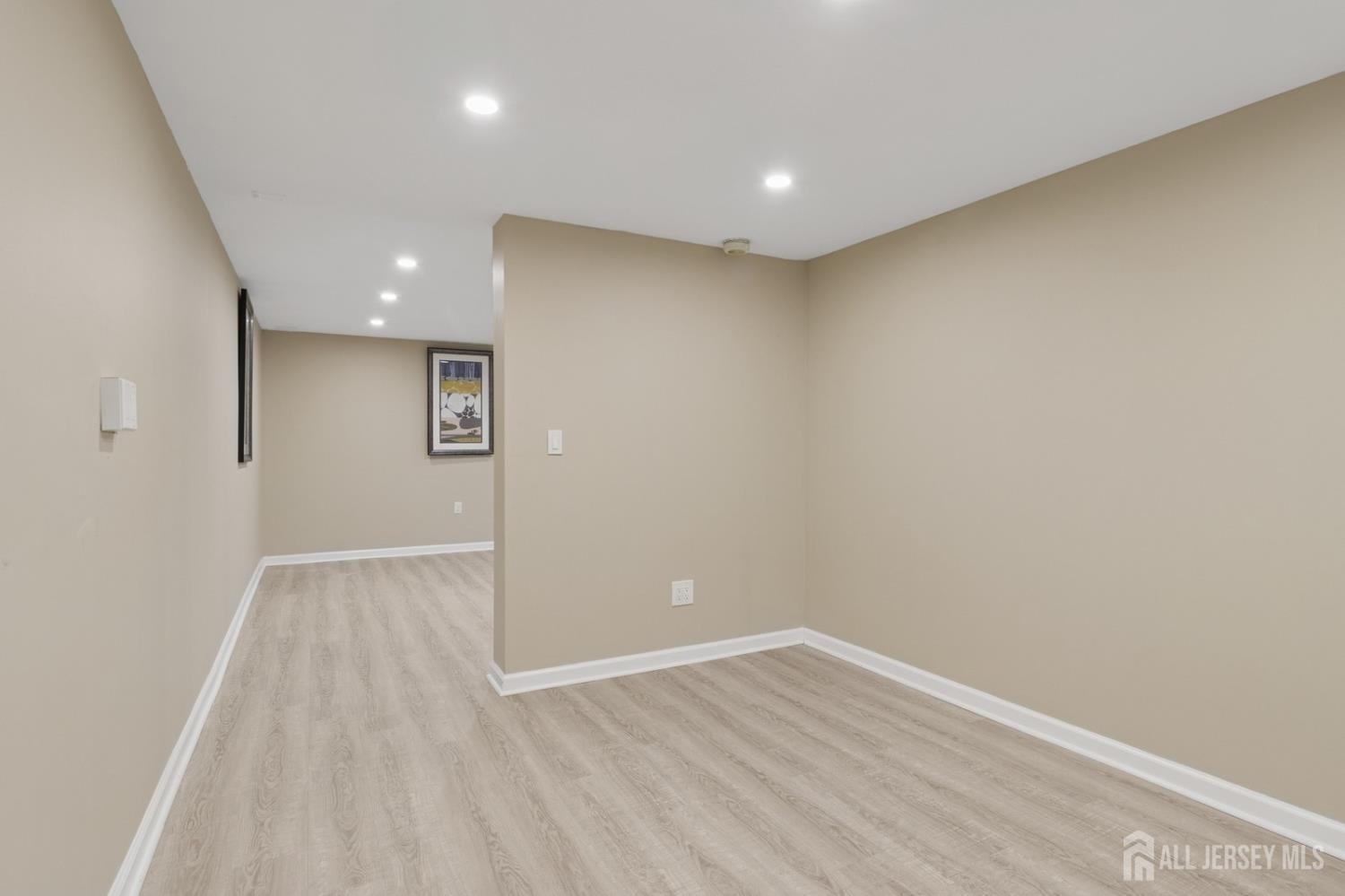 3 Cedar Lane Milltown, NJ 08850 - Photo 49 of 67 an empty room with wooden floor and windows