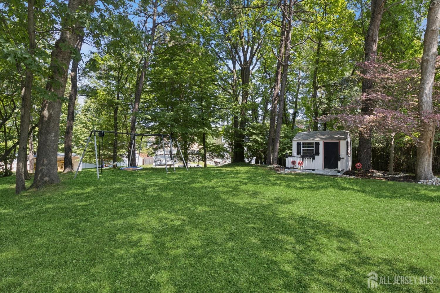 3 Cedar Lane Milltown, NJ 08850 - Photo 52 of 67 a view of a big yard with plants and large trees
