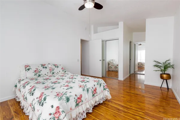 a bedroom with a bed and wooden floor