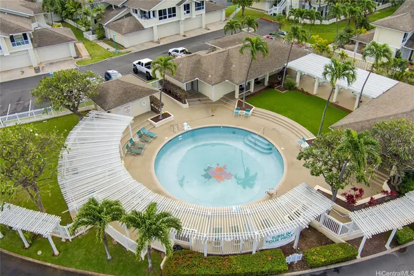 an aerial view of a house with garden space and street view
