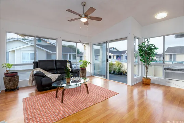 a living room with furniture and wooden floor