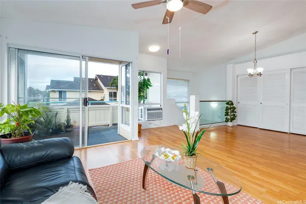 a living room with furniture and a floor to ceiling window