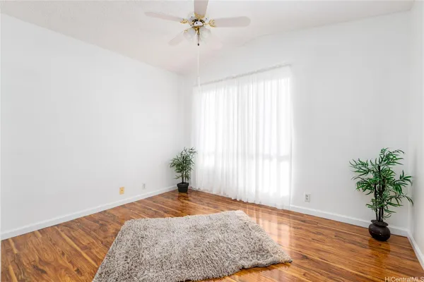a bedroom with a bed and a potted plant