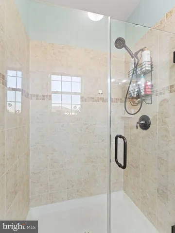 a bedroom with a dresser and mirror