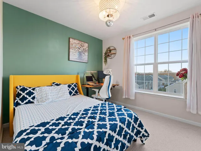 a bathroom with a granite countertop toilet and a sink