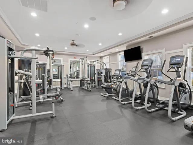 a dining room with furniture and a floor to ceiling window