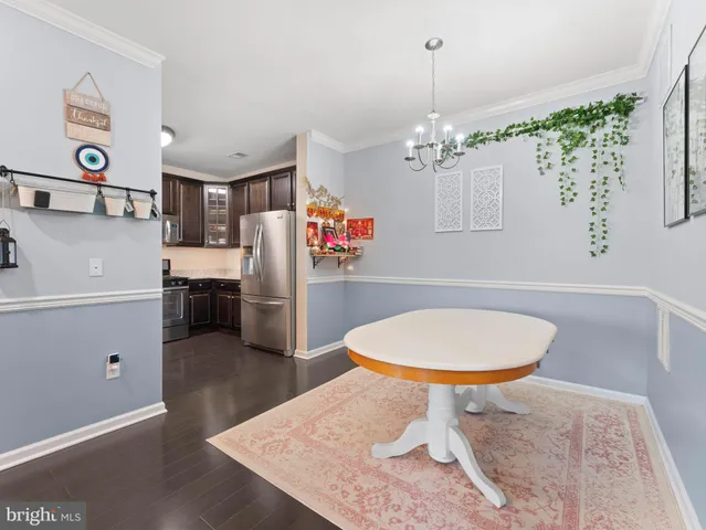 a kitchen with stainless steel appliances granite countertop a refrigerator sink and stove