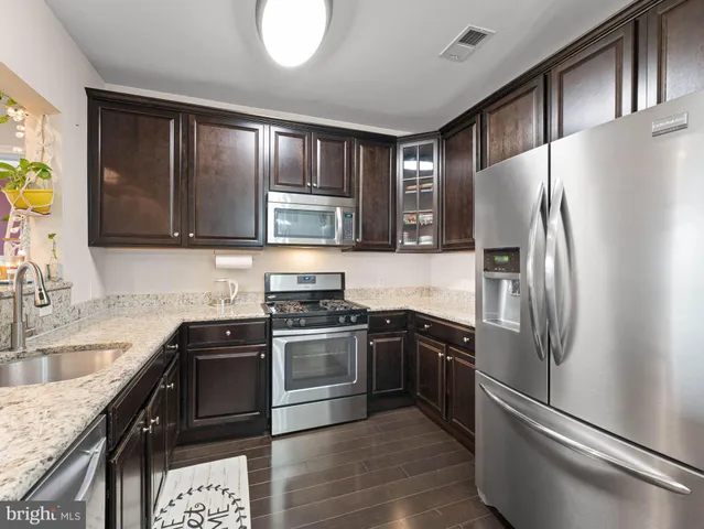 a kitchen with a sink stove and microwave