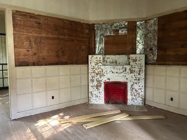 a living room with a fireplace and a flat screen tv