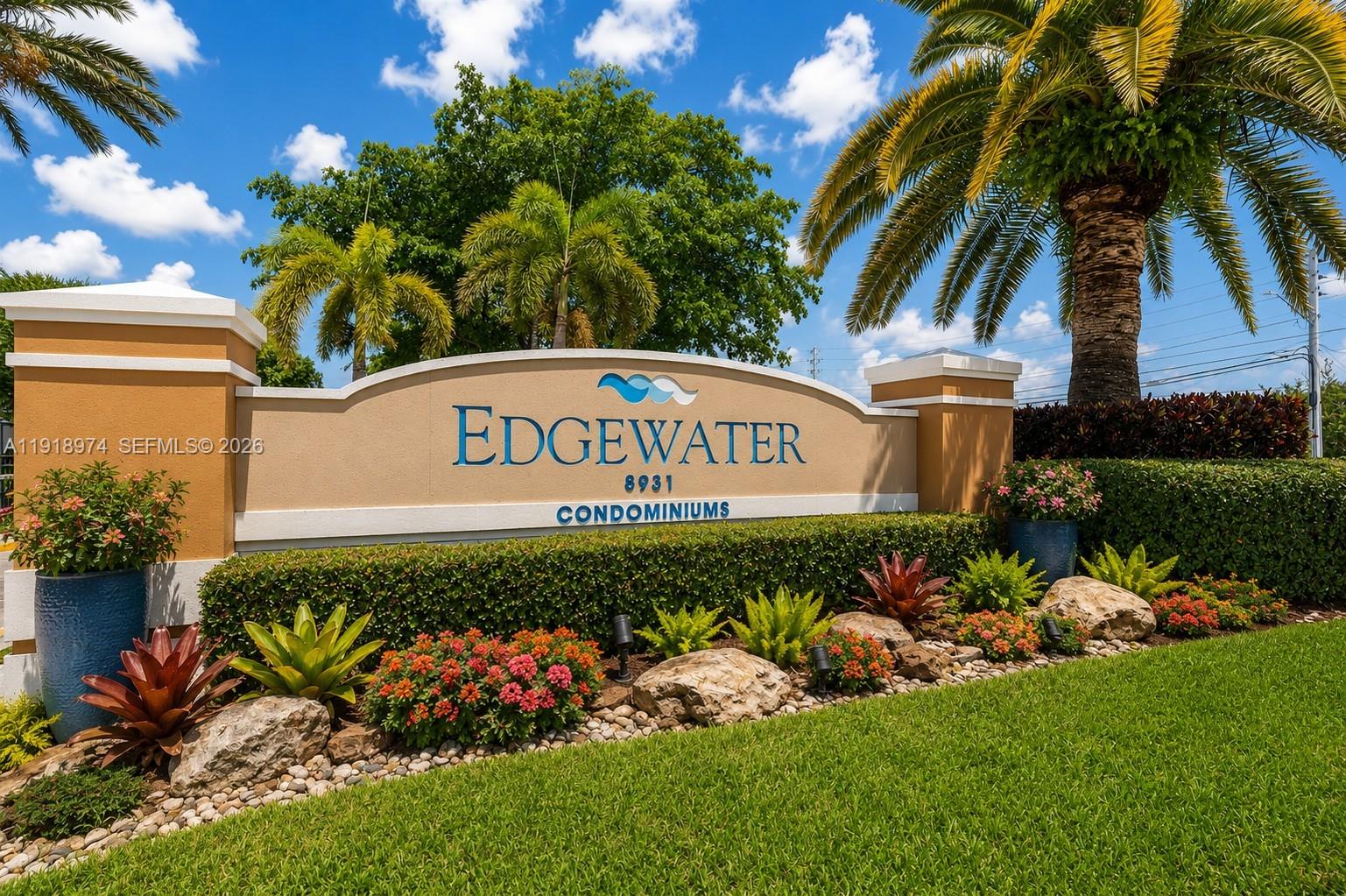 8801 Wiles Road, Unit 307 Coral Springs, FL 33067 - Photo 1 of 18 a sign that is in front of flowers