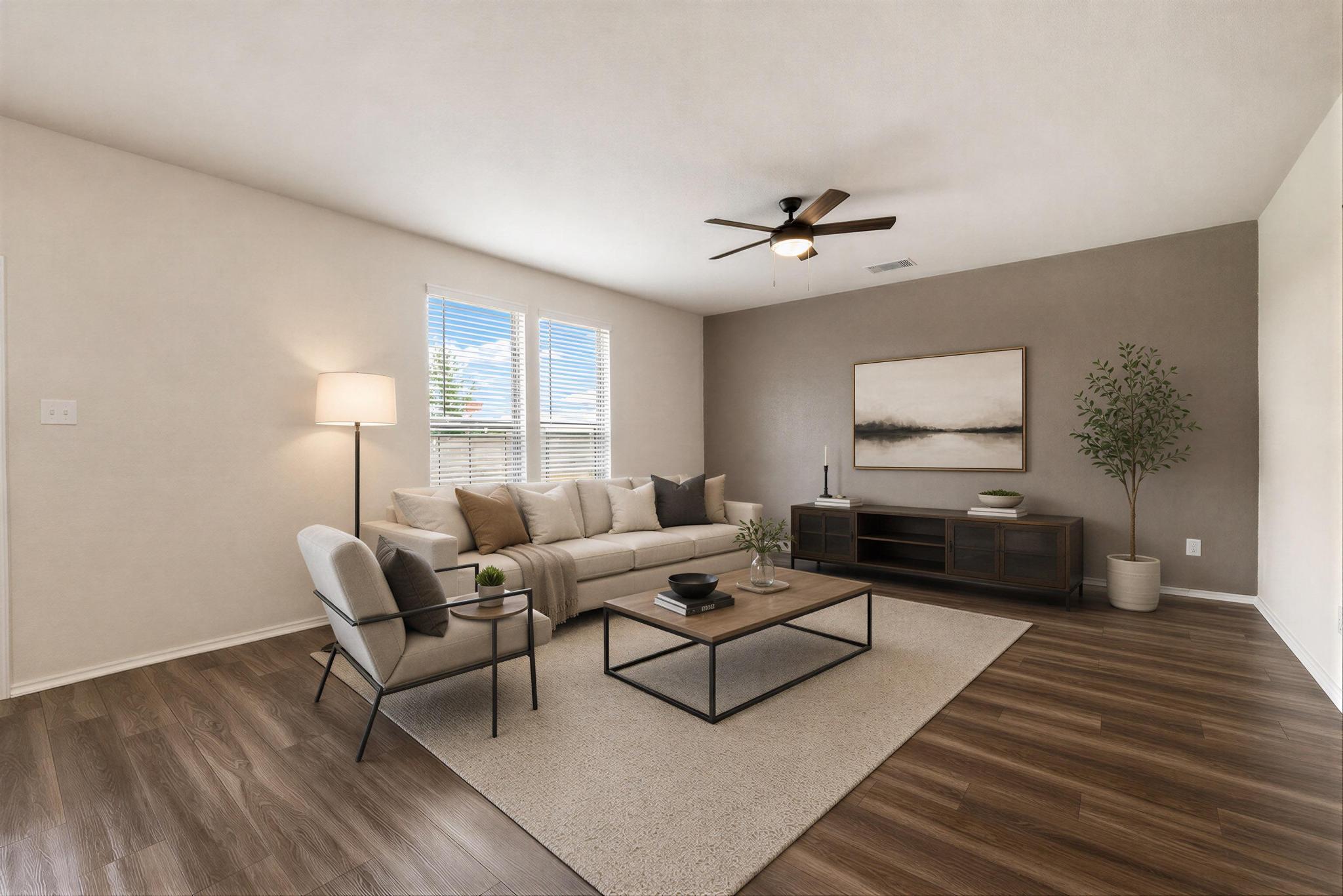 217 Innisfree Road Jarrell, TX 76537 - Photo 10 of 39 Hardwood-style flooring extends through this comfortable living space, centered by a modern ceiling fan. Virtually Staged