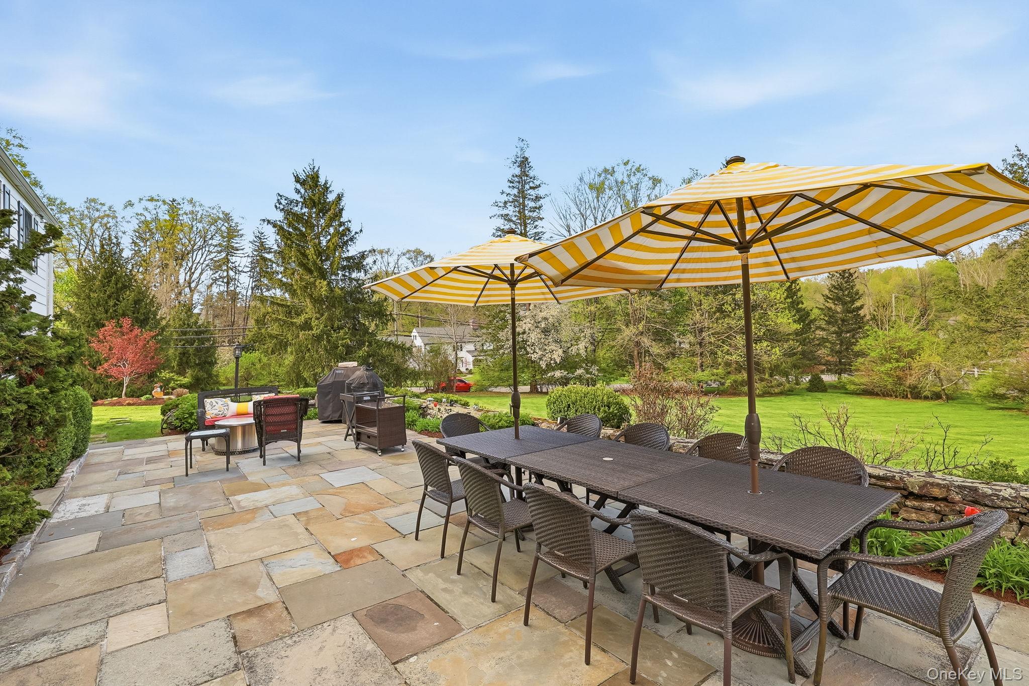 14 Annandale Road Chappaqua, NY 10514 - Photo 34 of 40 a view of an outdoor sitting area with furniture and umbrella