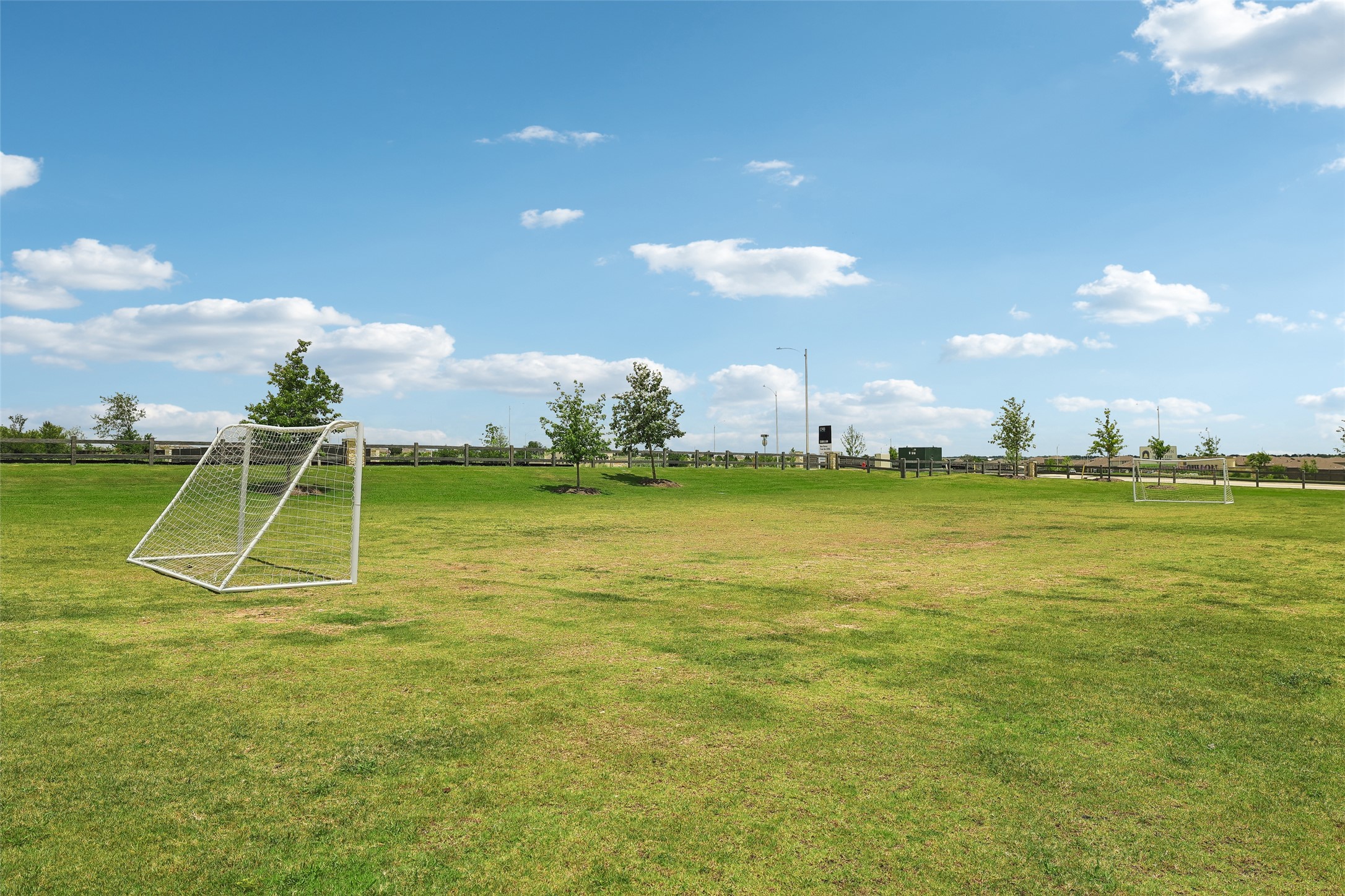 19805 Abigail Fillmore Road Manor, TX 78653 - Photo 36 of 40 Green expanse with a soccer goal, offering recreational enjoyment under the open sky.