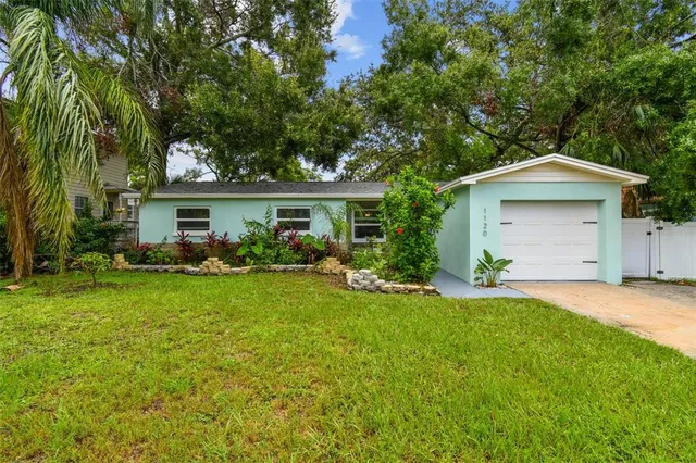 a front view of house with yard and green space