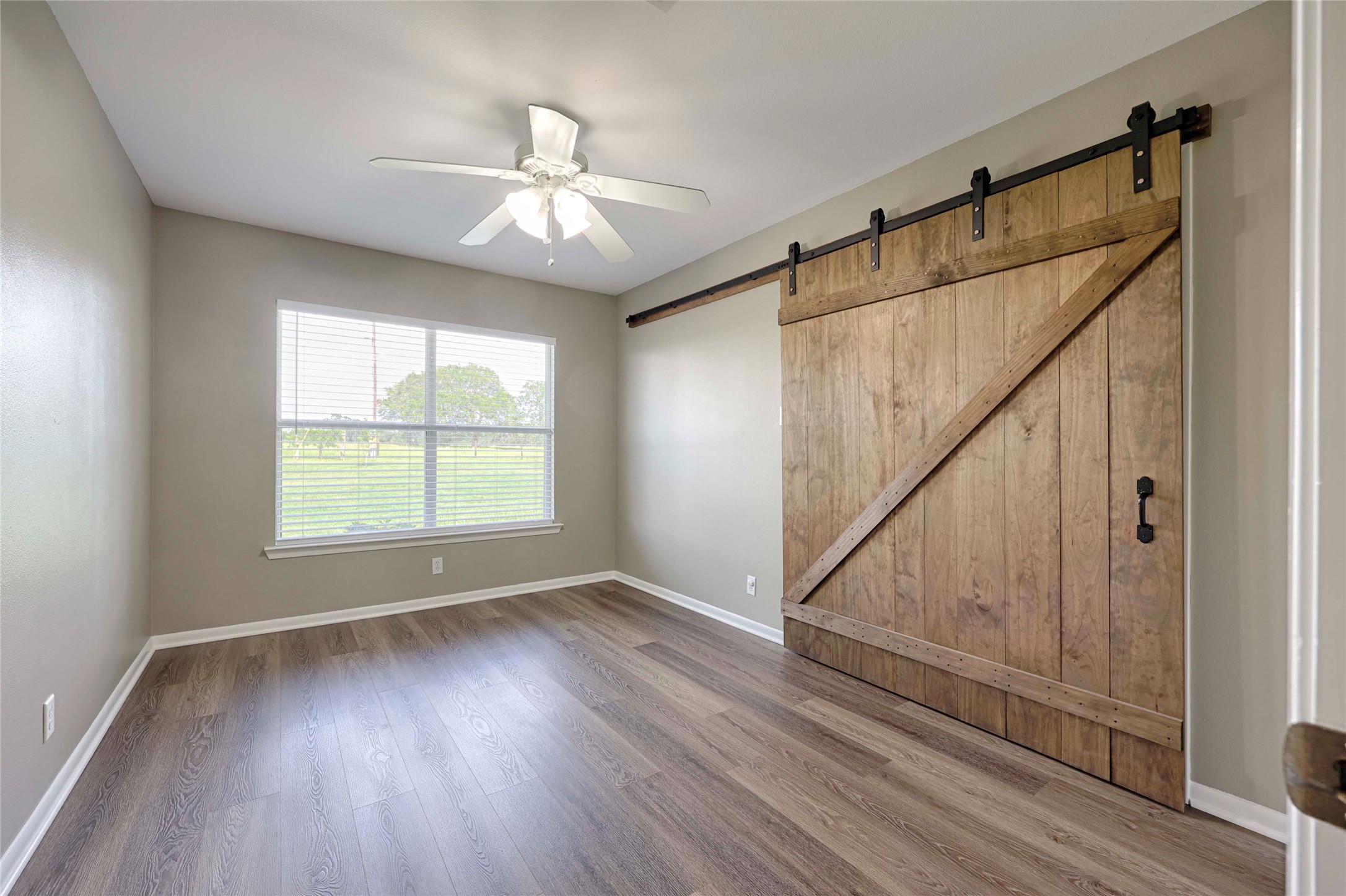 3545 East I- 10 Frontage Road Schulenburg, TX 78956 - Photo 20 of 40 an empty room with wooden floor fan and windows