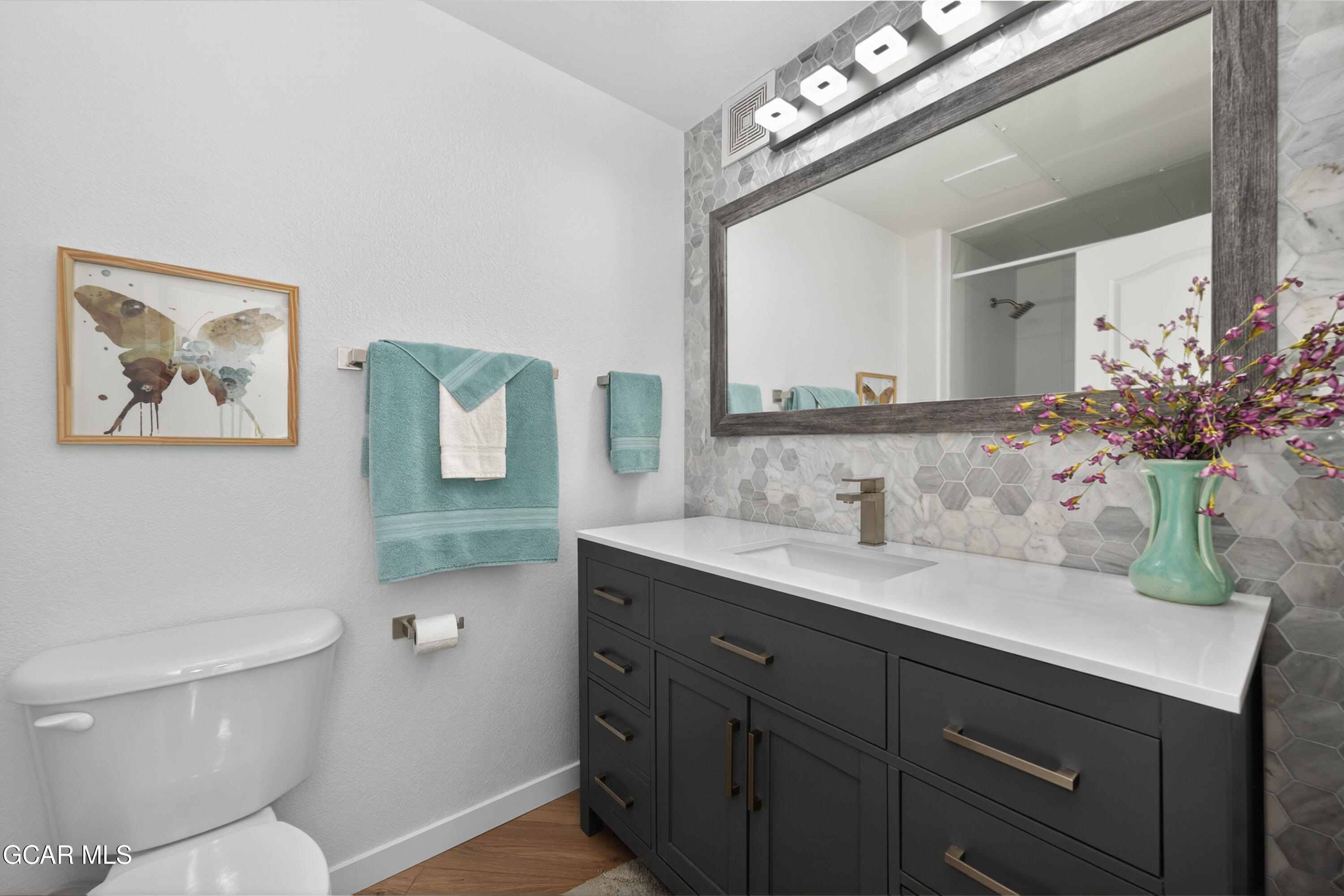 160 Village Road, Unit F207 Granby, CO 80446 - Photo 16 of 28 a bathroom with a toilet a sink and mirror
