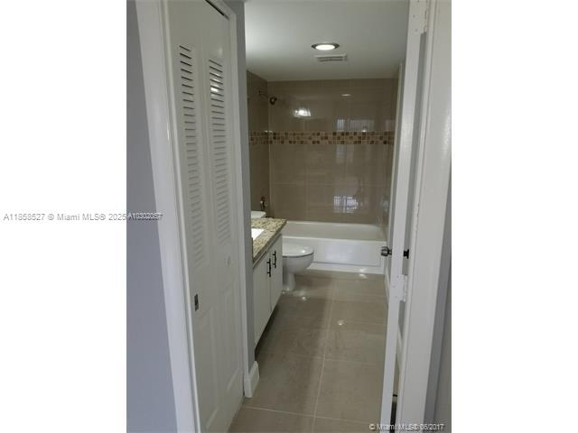 4160 Inverrary Drive, Unit 505 Lauderhill, FL 33319 - Photo 11 of 16 a bathroom with a glass shower door