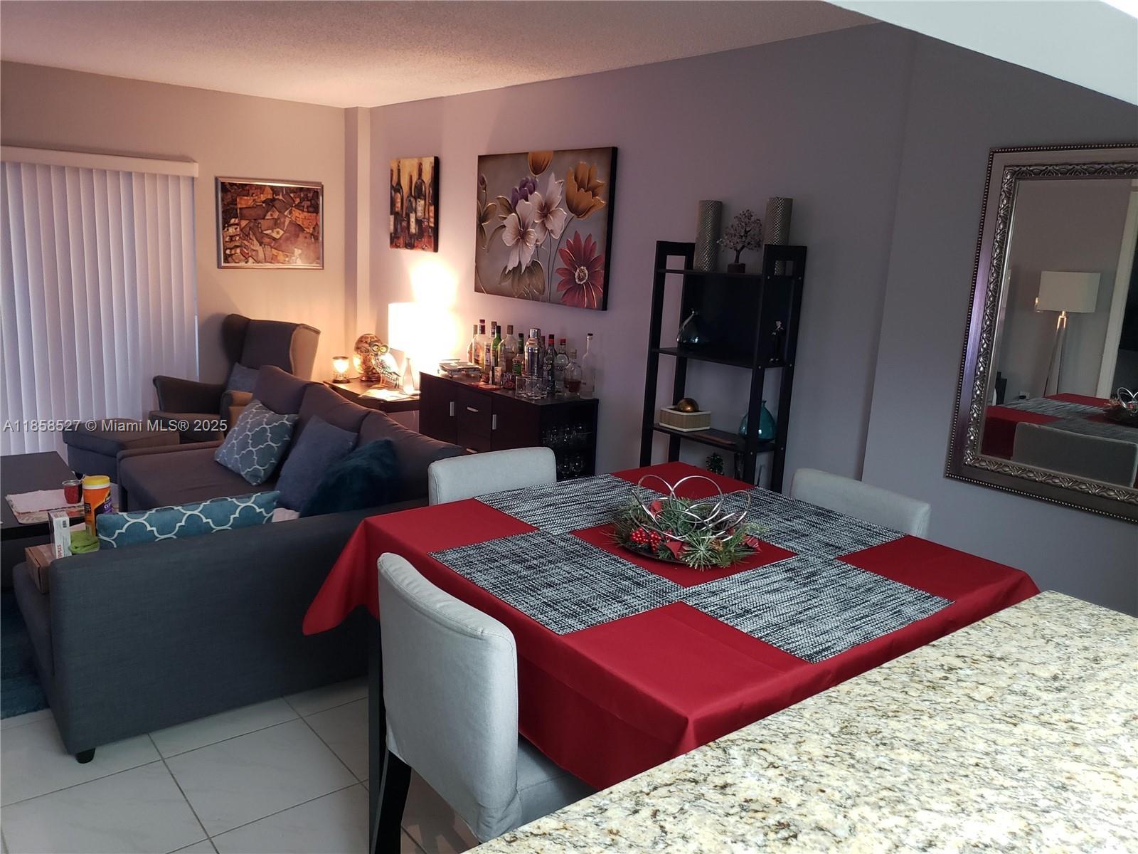 4160 Inverrary Drive, Unit 505 Lauderhill, FL 33319 - Photo 13 of 16 a living room with furniture and rug