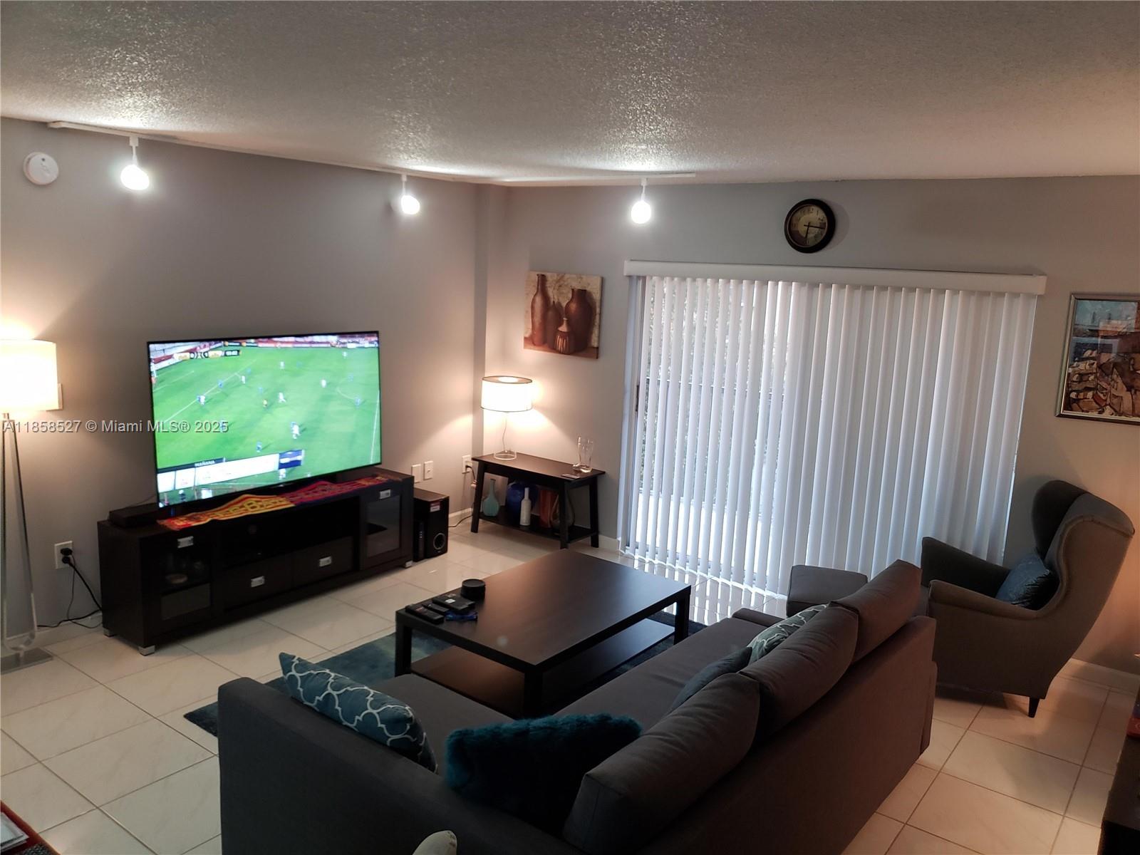4160 Inverrary Drive, Unit 505 Lauderhill, FL 33319 - Photo 14 of 16 a living room with furniture and a flat screen tv