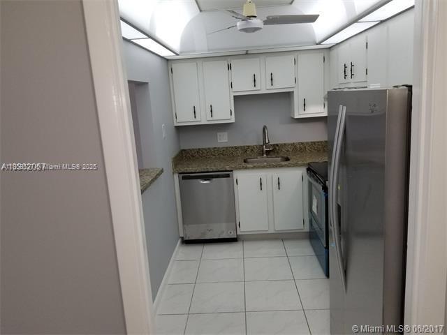 4160 Inverrary Drive, Unit 505 Lauderhill, FL 33319 - Photo 2 of 16 a kitchen with stainless steel appliances granite countertop a refrigerator and a stove top oven