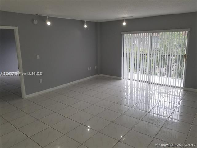4160 Inverrary Drive, Unit 505 Lauderhill, FL 33319 - Photo 3 of 16 an empty room with sliding door