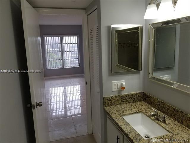 4160 Inverrary Drive, Unit 505 Lauderhill, FL 33319 - Photo 8 of 16 a bathroom with a granite countertop sink a mirror and shower