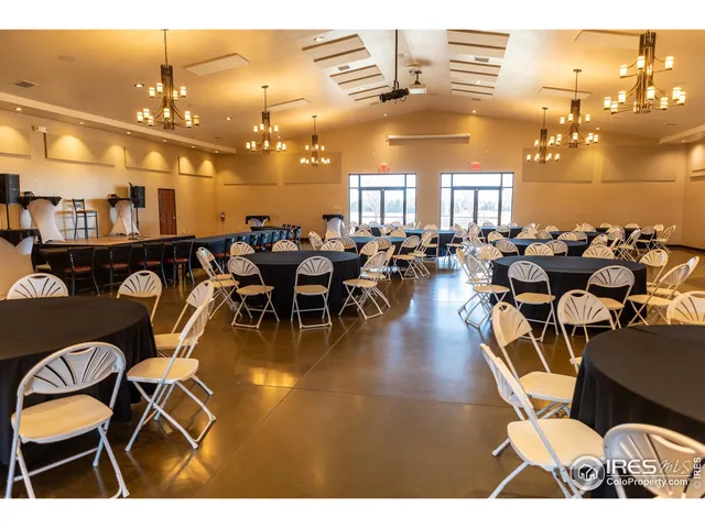 a room with lots of people and lots of wooden cabinets