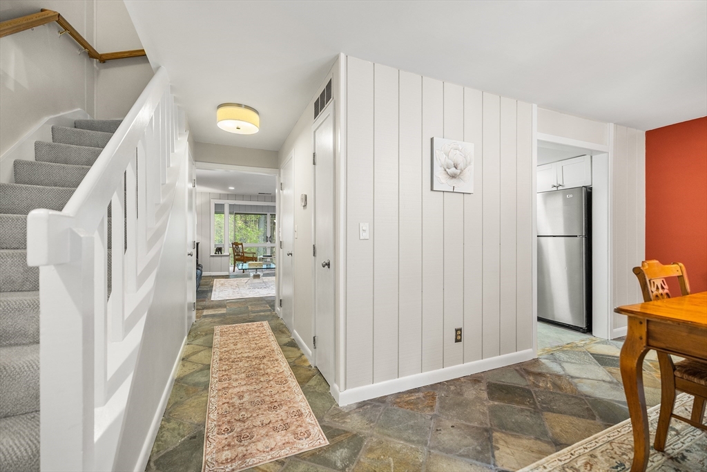 370 Great Road, Unit 8 Acton, MA 01720 - Photo 12 of 27 a view of a hallway to a livingroom with furniture and front door