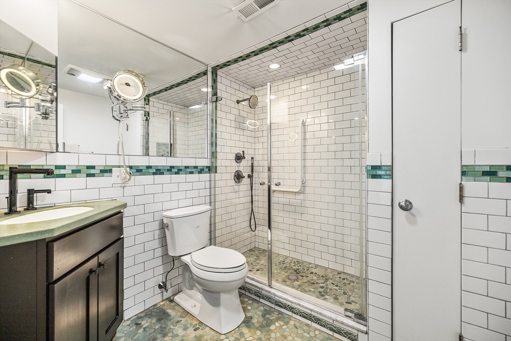 370 Great Road, Unit 8 Acton, MA 01720 - Photo 17 of 27 a bathroom with a sink a toilet and shower