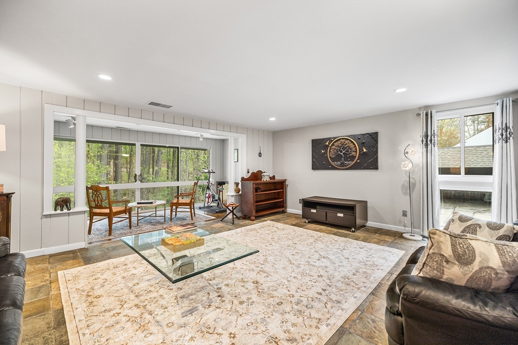 370 Great Road, Unit 8 Acton, MA 01720 - Photo 2 of 27 a living room with furniture and a flat screen tv