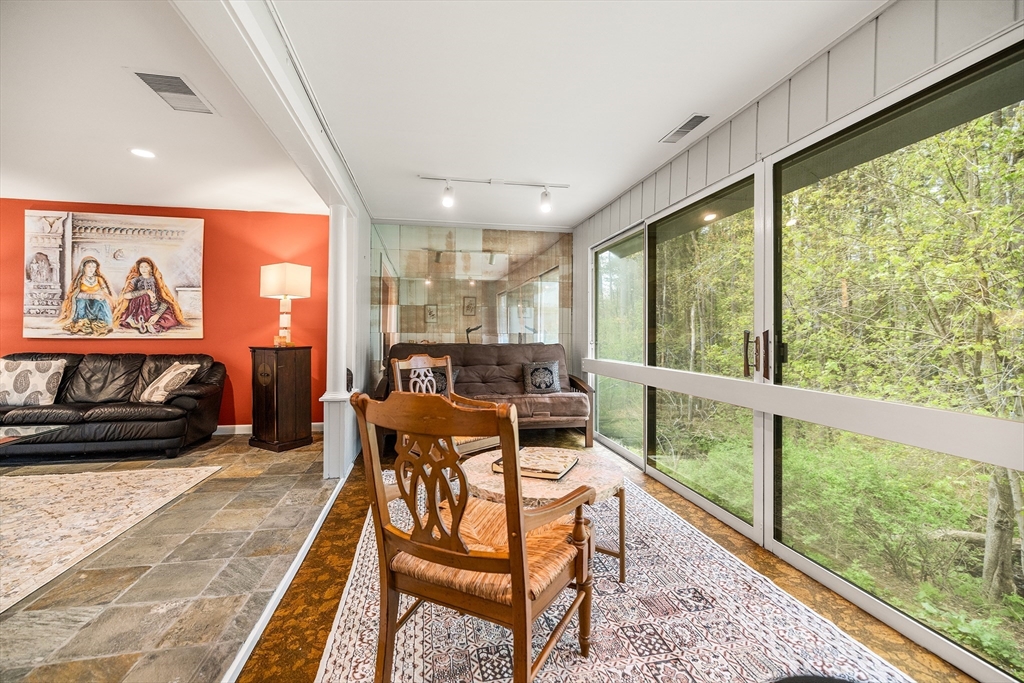 370 Great Road, Unit 8 Acton, MA 01720 - Photo 3 of 27 a living room with furniture a rug potted plant and a large window
