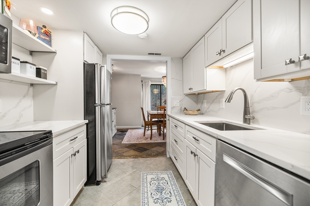 370 Great Road, Unit 8 Acton, MA 01720 - Photo 8 of 27 a kitchen with a sink dishwasher a stove and a refrigerator