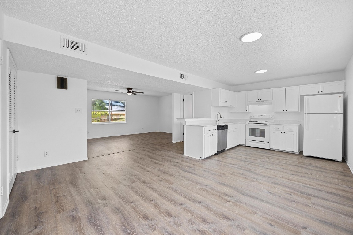 5211 Thunderbird Street, Unit A Lago Vista, TX 78645 - Photo 26 of 26 a view of a kitchen with wooden floor and electronic appliances