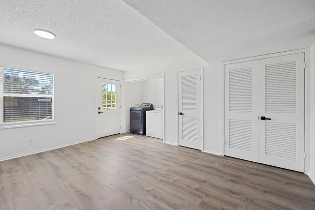 a view of a kitchen with wooden floor and electronic appliances