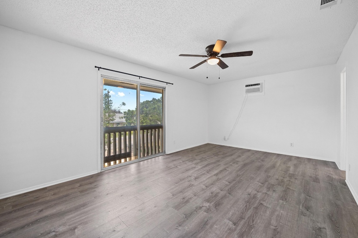 5211 Thunderbird Street, Unit A Lago Vista, TX 78645 - Photo 17 of 26 a view of a livingroom with a ceiling fan and window