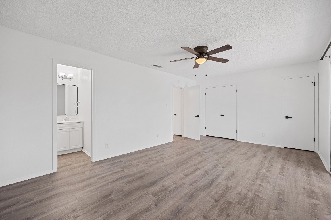 5211 Thunderbird Street, Unit A Lago Vista, TX 78645 - Photo 18 of 26 wooden floor in an empty room