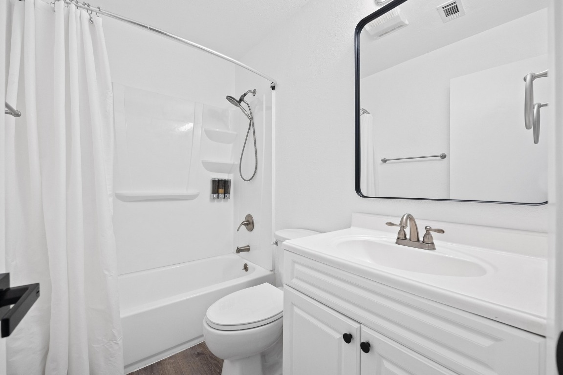 5211 Thunderbird Street, Unit A Lago Vista, TX 78645 - Photo 21 of 26 a bathroom with a sink a toilet and shower