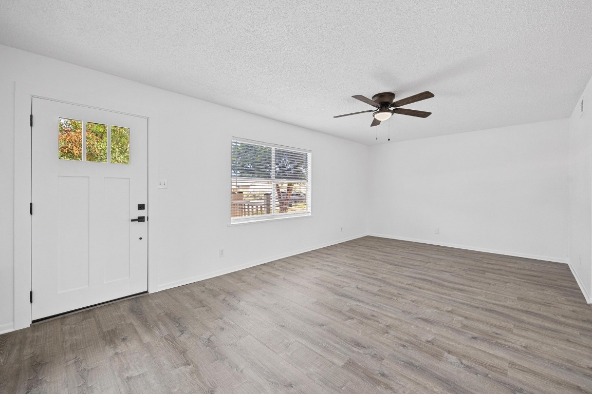 5211 Thunderbird Street, Unit A Lago Vista, TX 78645 - Photo 7 of 26 an empty room with fan and windows