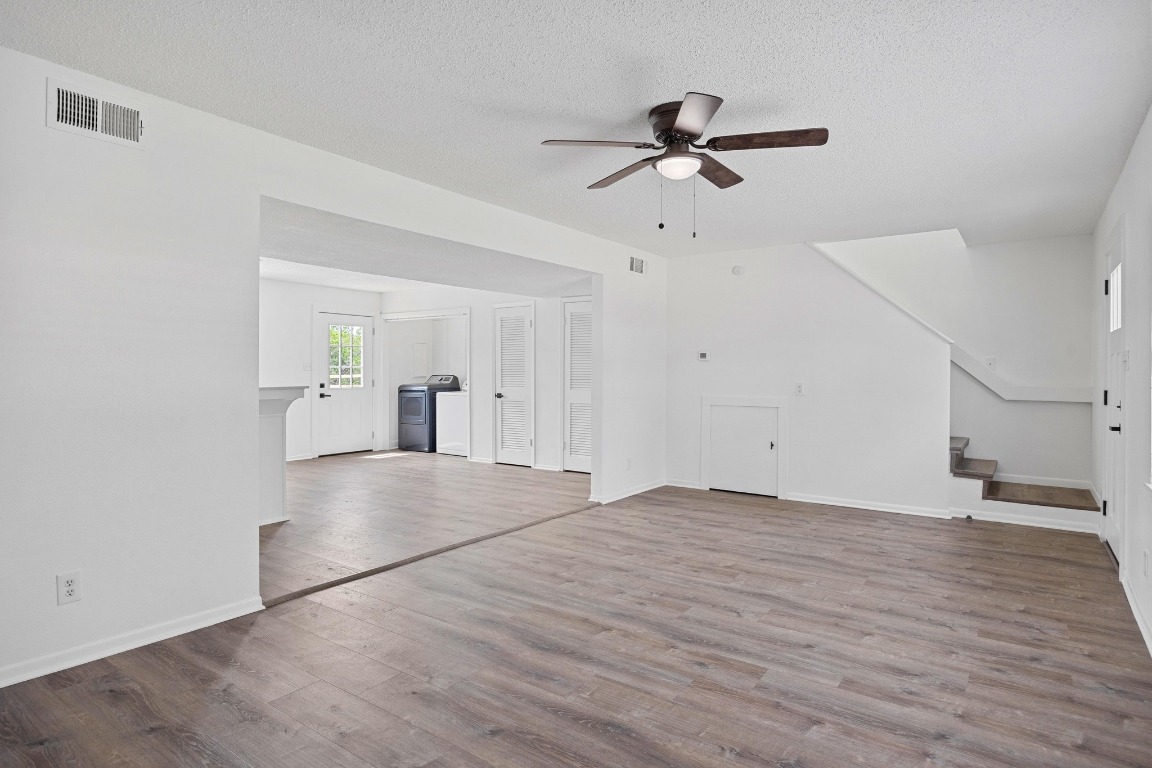 5211 Thunderbird Street, Unit A Lago Vista, TX 78645 - Photo 10 of 26 a view of empty room with wooden floor and ceiling fan