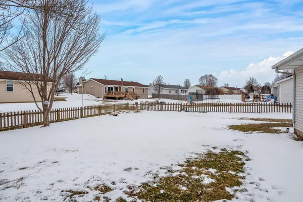 a view of a house with a snow in the yard