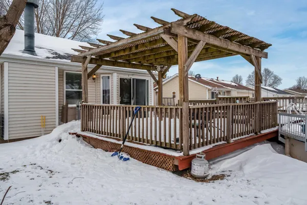 a view of an empty room with furniture and a window